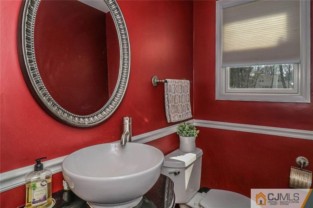 16 Clive Hills Road Edison, NJ 08820 - Photo 14 of 25 a bathroom with a toilet and a mirror