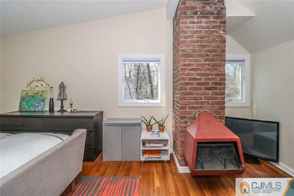 16 Clive Hills Road Edison, NJ 08820 - Photo 17 of 25 a living room with furniture and a wooden floor