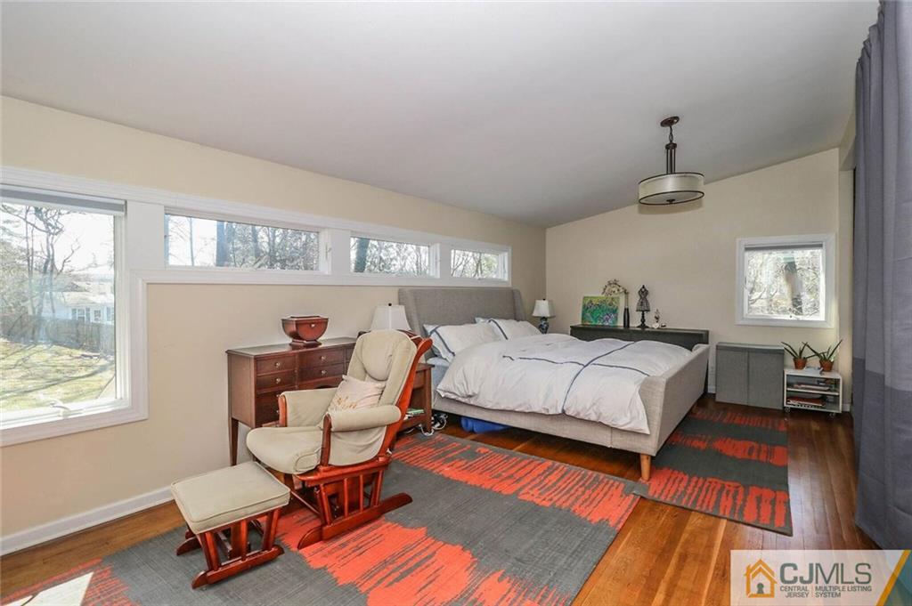 16 Clive Hills Road Edison, NJ 08820 - Photo 18 of 25 a bedroom with a bed and wooden floor