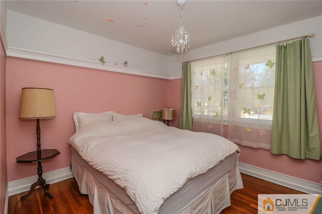 16 Clive Hills Road Edison, NJ 08820 - Photo 19 of 25 a bedroom with a bed and a lamp