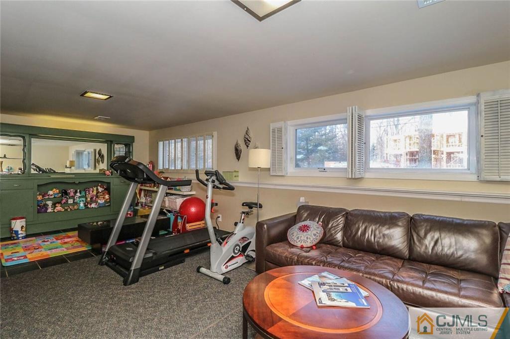 16 Clive Hills Road Edison, NJ 08820 - Photo 20 of 25 a living room with furniture a air conditioner and a window