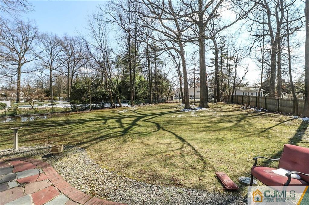 16 Clive Hills Road Edison, NJ 08820 - Photo 23 of 25 a swimming pool with trees in the background