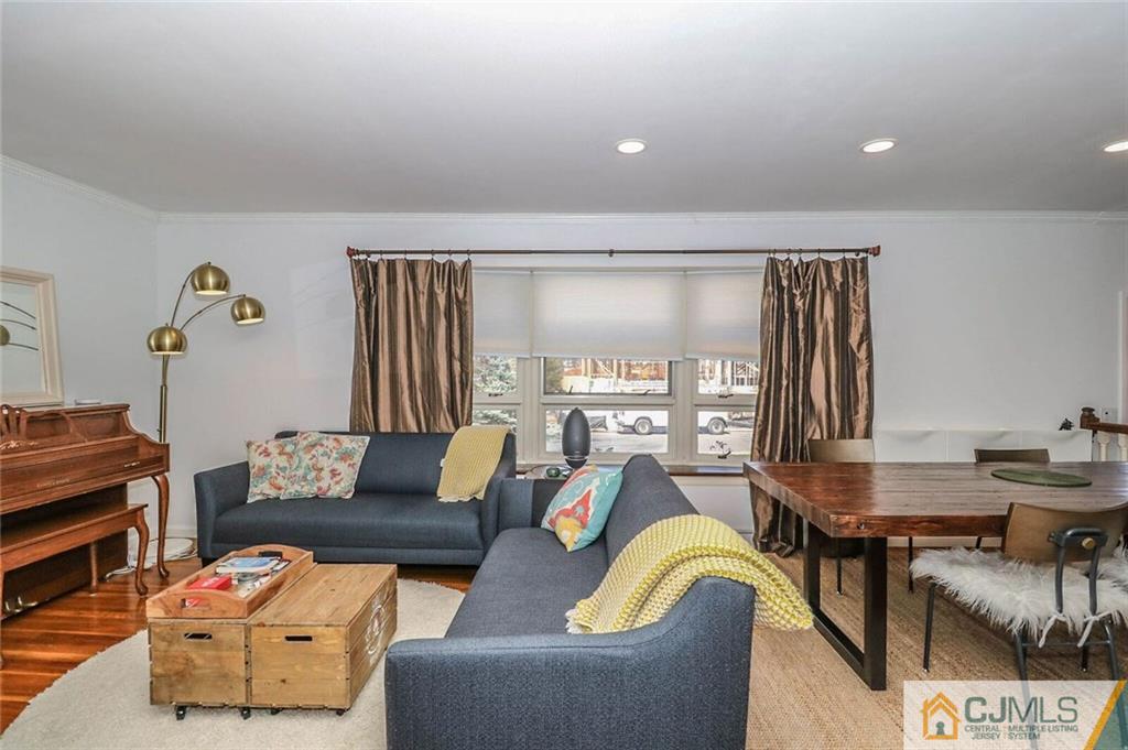 16 Clive Hills Road Edison, NJ 08820 - Photo 6 of 25 a living room with furniture and a flat screen tv