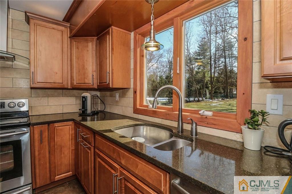 16 Clive Hills Road Edison, NJ 08820 - Photo 7 of 25 a kitchen with a sink and a stove top oven