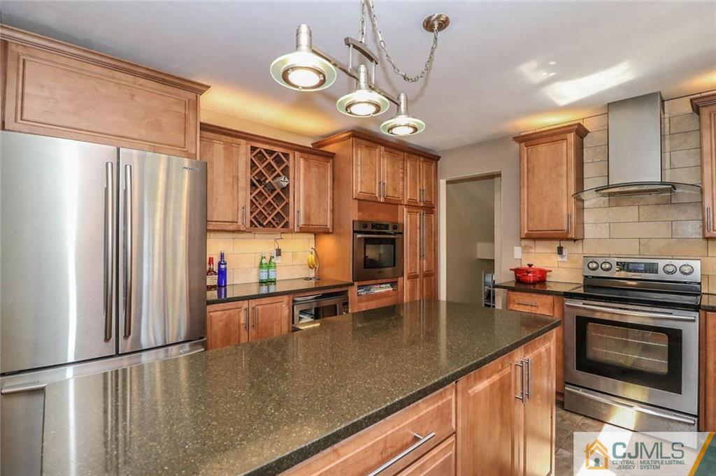16 Clive Hills Road Edison, NJ 08820 - Photo 8 of 25 a kitchen with stainless steel appliances granite countertop a sink a stove and a refrigerator