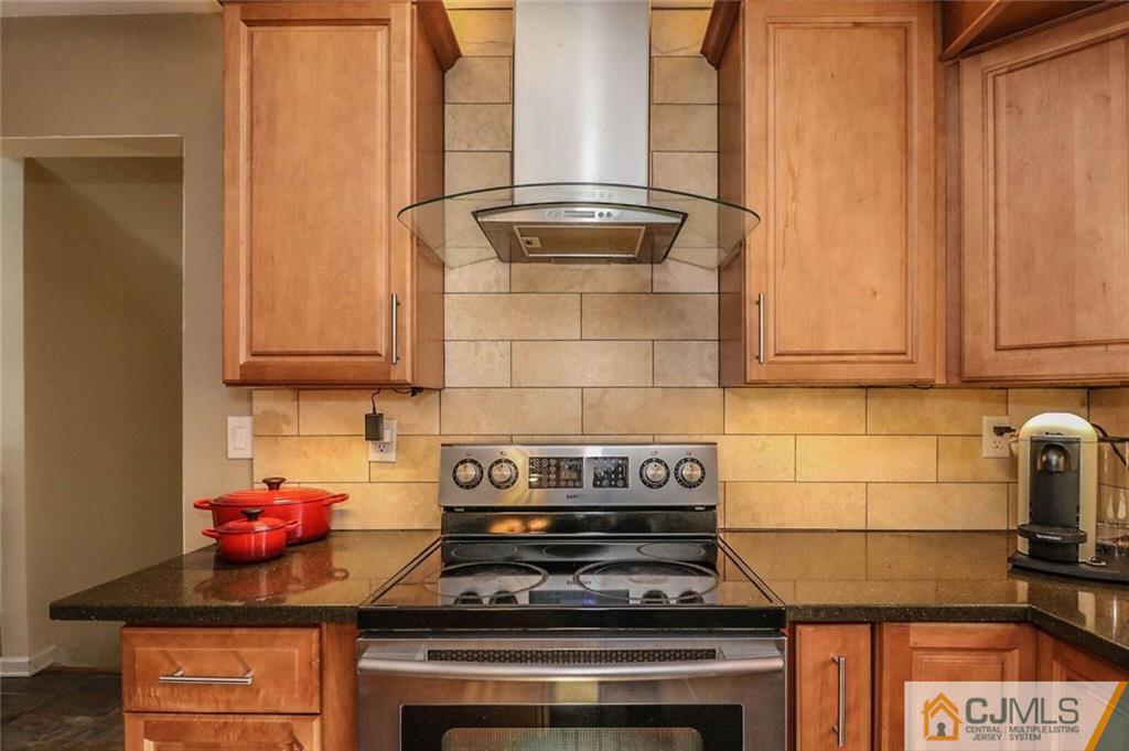 16 Clive Hills Road Edison, NJ 08820 - Photo 9 of 25 a stove top oven sitting inside of a kitchen