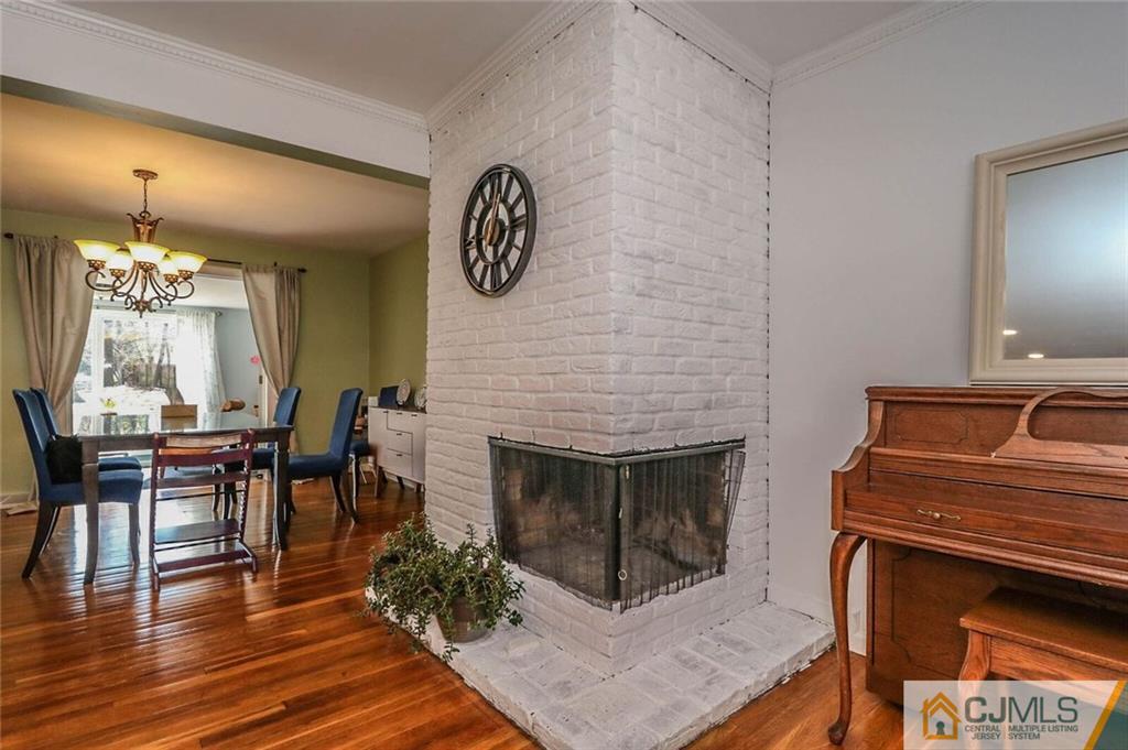 16 Clive Hills Road Edison, NJ 08820 - Photo 10 of 25 a living room with furniture and a fireplace