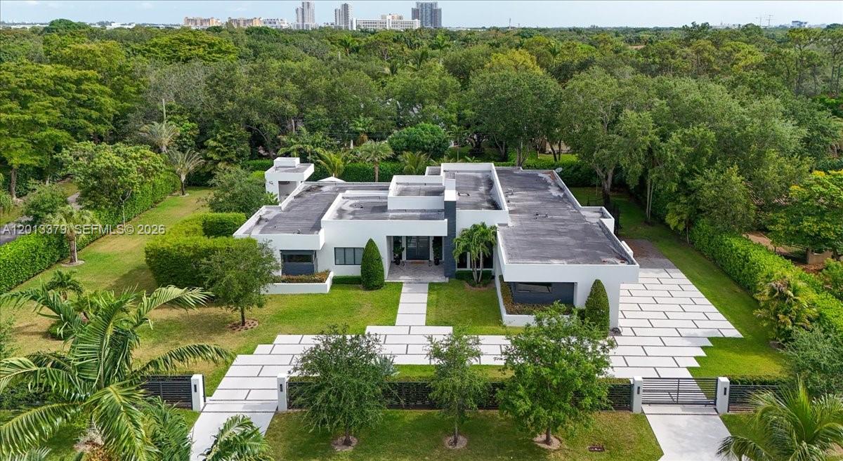 6785 Southwest 99th Terrace Pinecrest, FL 33156 - Photo 4 of 67 an aerial view of a house with swimming pool and garden