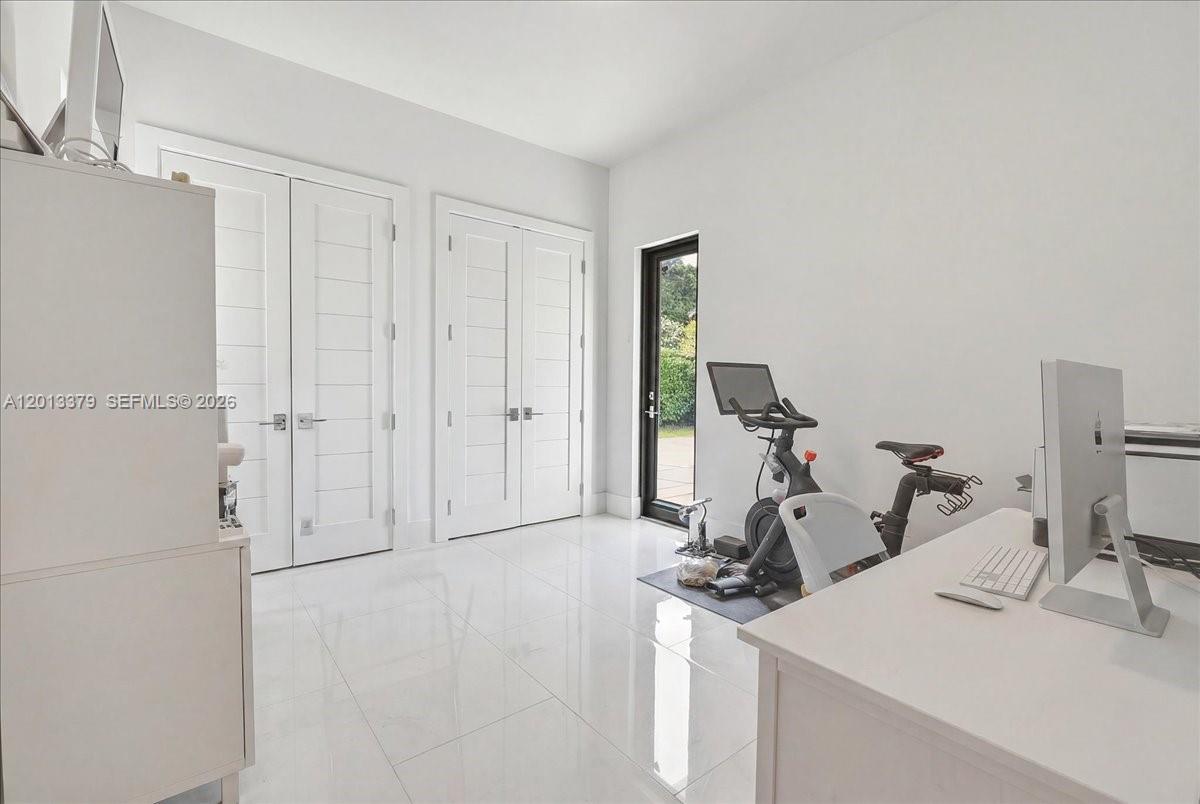6785 Southwest 99th Terrace Pinecrest, FL 33156 - Photo 54 of 67 a view of a room with gym equipment