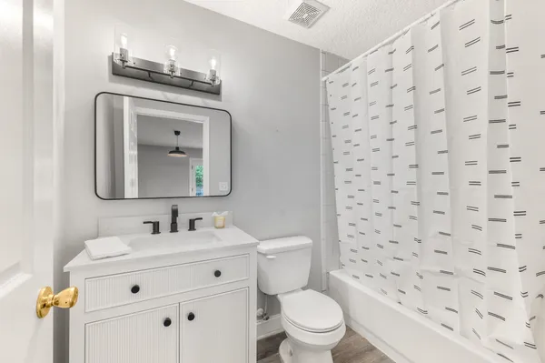a white toilet sitting next to a bathroom sink