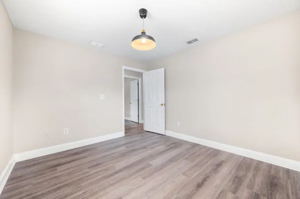 a view of a brick house with a large window and plants