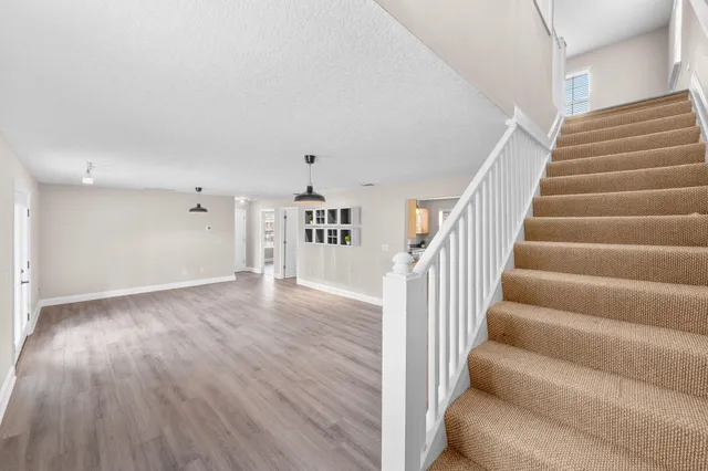 a view of entryway and hall with wooden floor