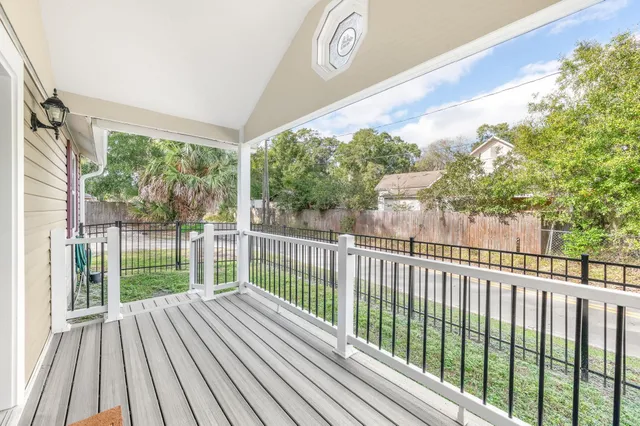 a view of a balcony with wooden floor