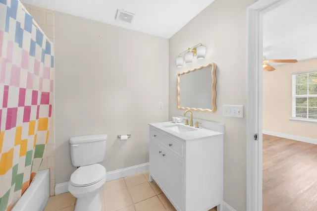 a bathroom with a toilet a sink and a mirror