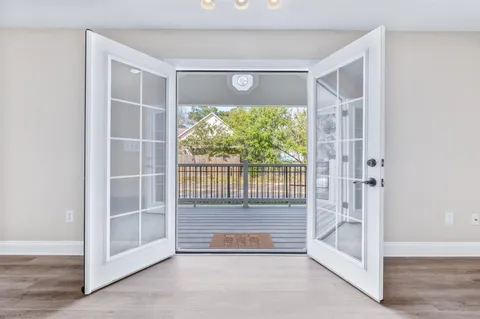 a view of entryway with a floor to ceiling window and wooden floor