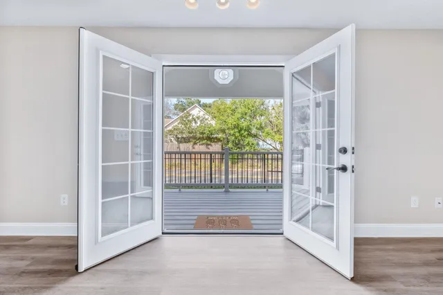 a view of entryway with a floor to ceiling window and wooden floor