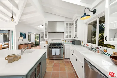 a kitchen with a sink stove and cabinets