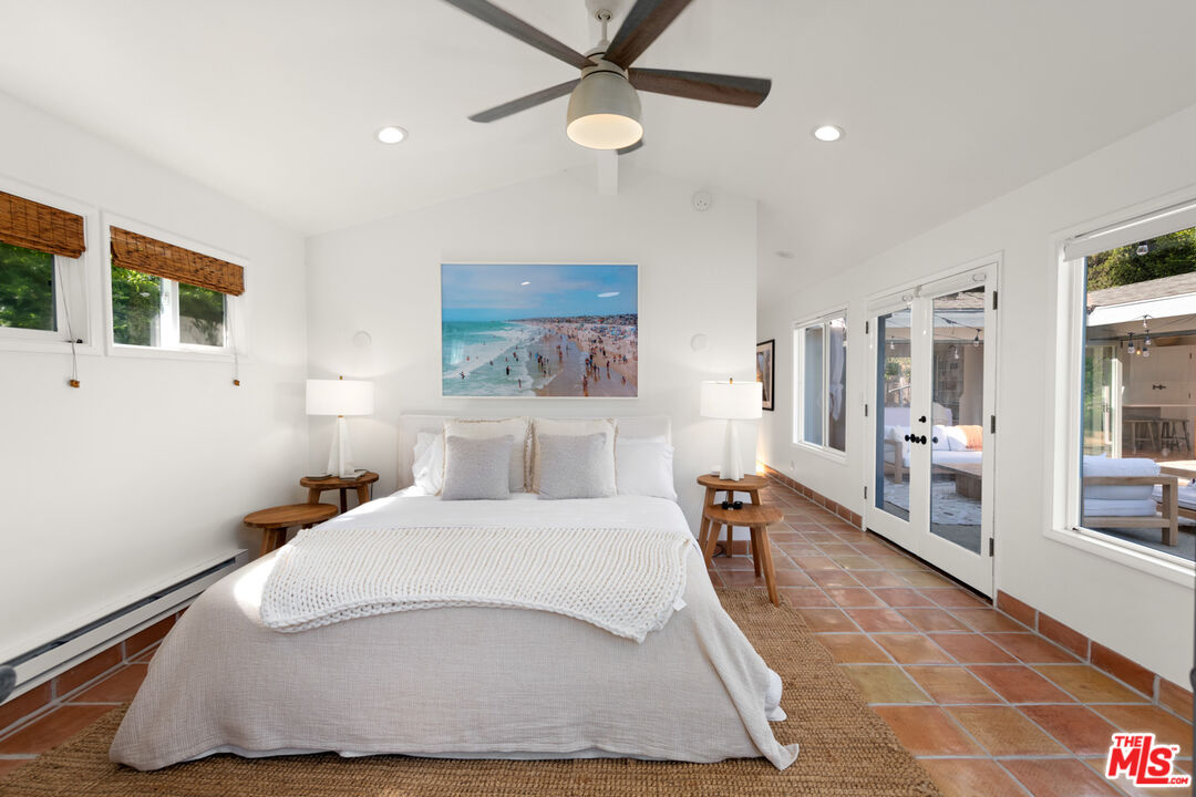 31562 Broad Beach Road Malibu, CA 90265 - Photo 16 of 31 a bedroom with a large bed and a chandelier