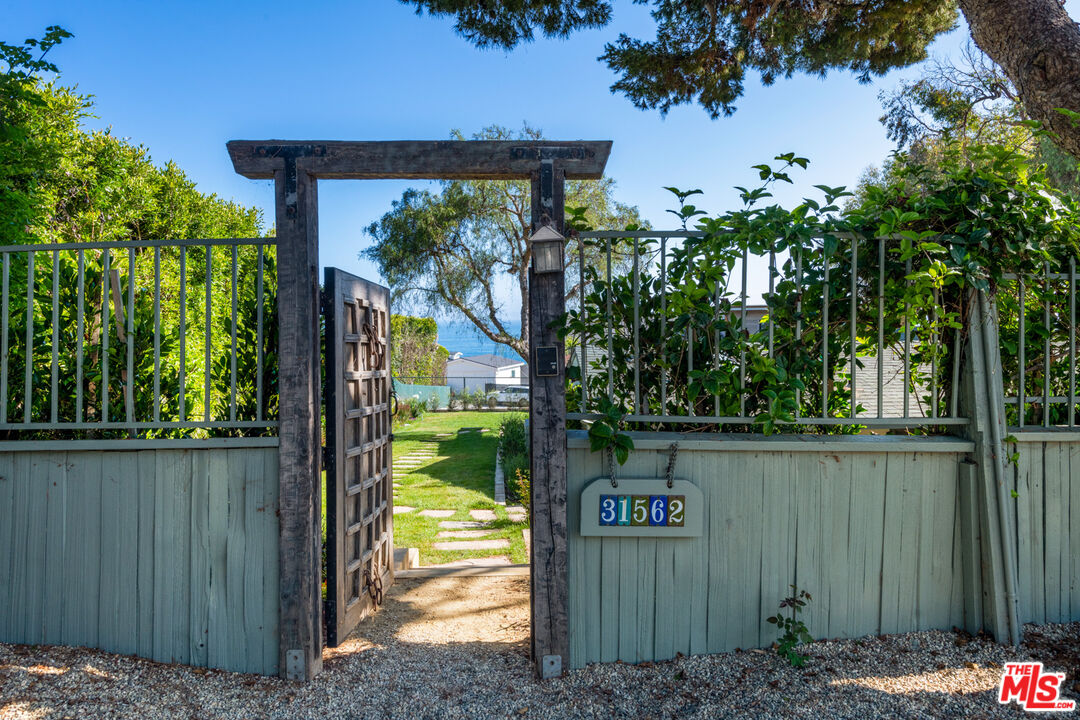 31562 Broad Beach Road Malibu, CA 90265 - Photo 2 of 31 a view of a wooden fence and a tree