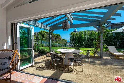 an aerial view of a houses with a yard