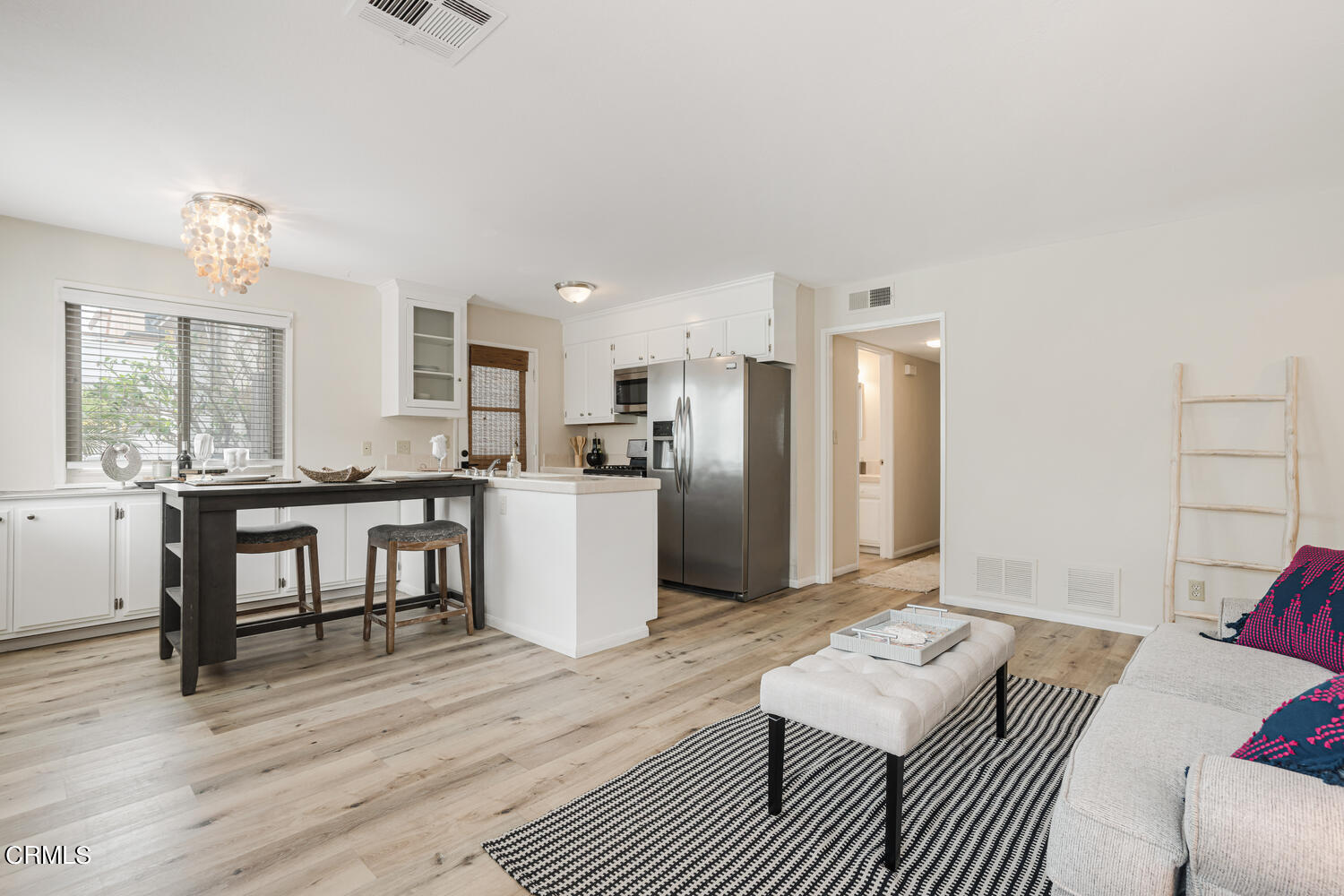 3700 Ocean Drive Oxnard, CA 93035 - Photo 35 of 55 a living room with furniture a refrigerator and kitchen view