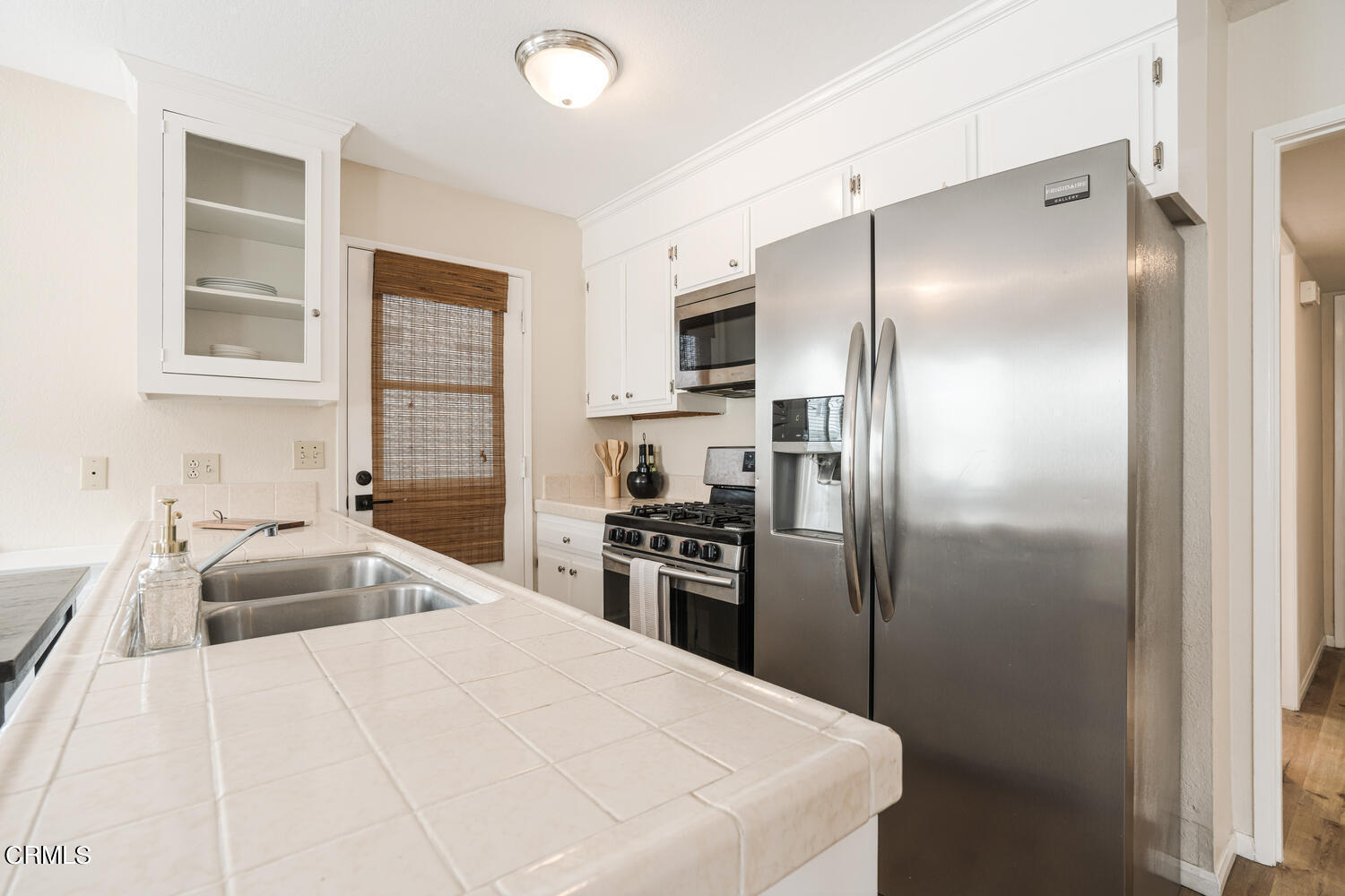 3700 Ocean Drive Oxnard, CA 93035 - Photo 37 of 55 a kitchen with granite countertop a refrigerator and a sink