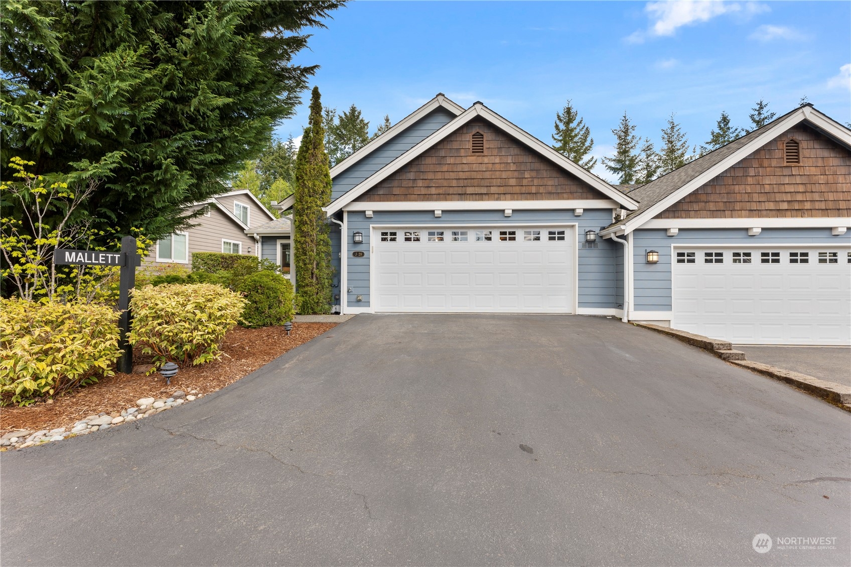 160 East Soderberg Road, Unit J28 Allyn, WA 98524 - Photo 2 of 39 a view of a house with a yard and garage