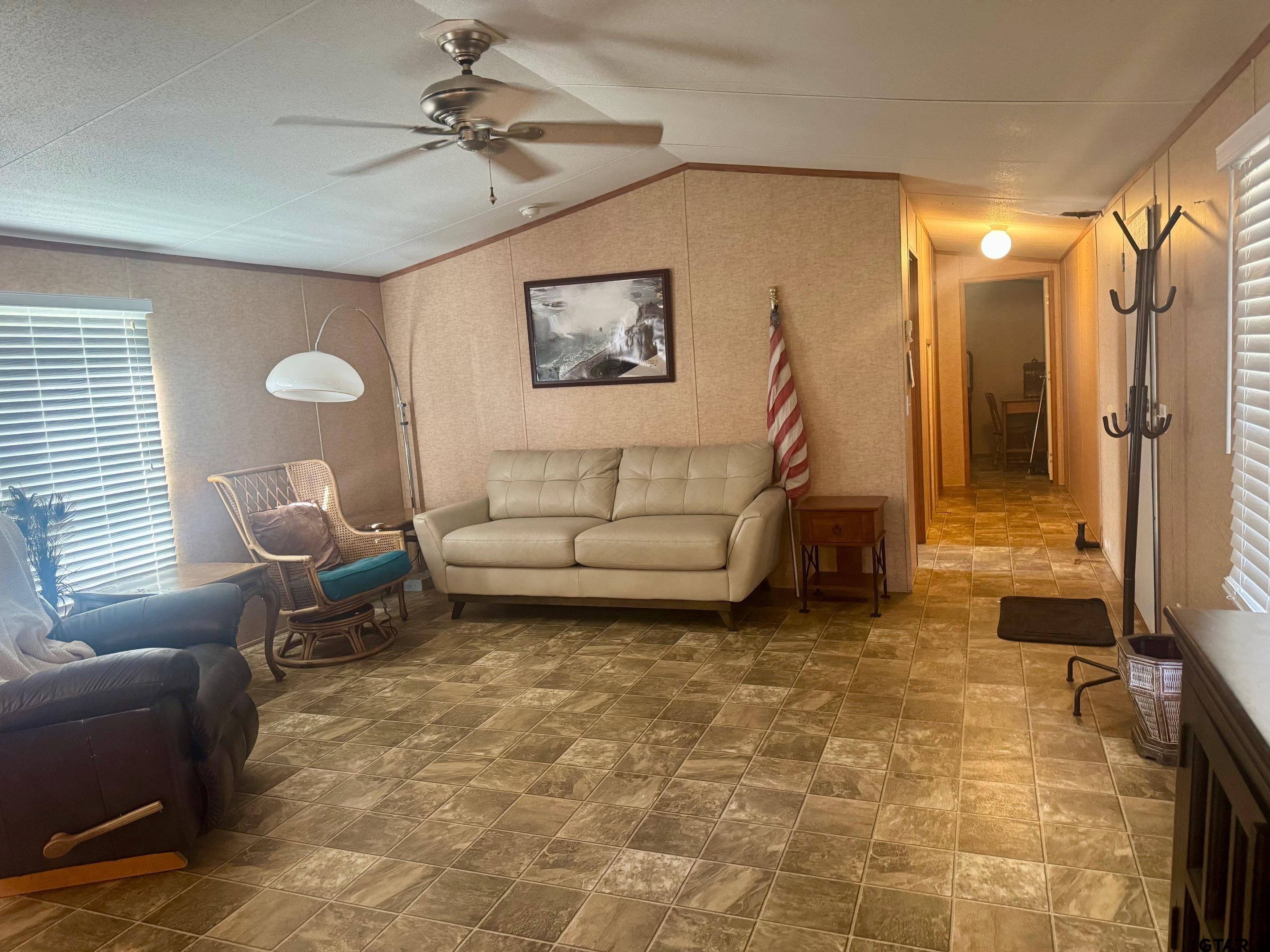 244 County Road 2602 Pittsburg, TX 75686 - Photo 11 of 22 a living room with patio furniture and a chandelier