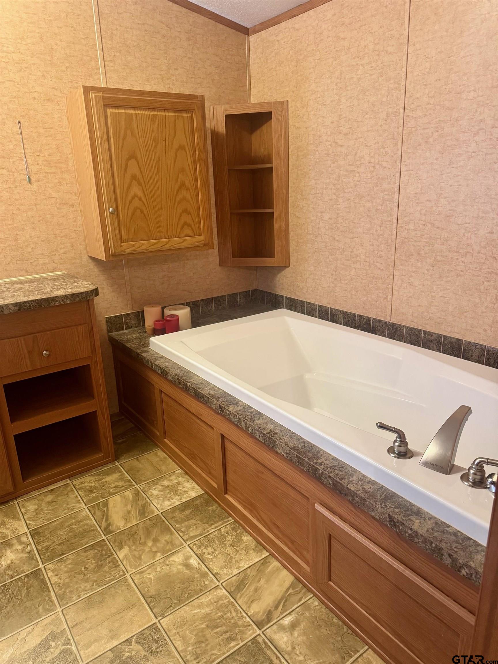 244 County Road 2602 Pittsburg, TX 75686 - Photo 13 of 22 a bathroom with a bathtub and a sink