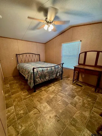 a bed sitting in a room next to a window
