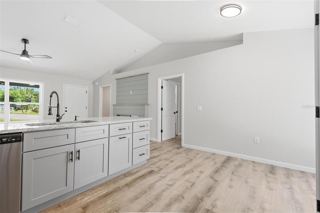1730 Berrybush Street Bunnell, FL 32110 - Photo 11 of 43 a spacious bathroom with a granite countertop sink mirror and a