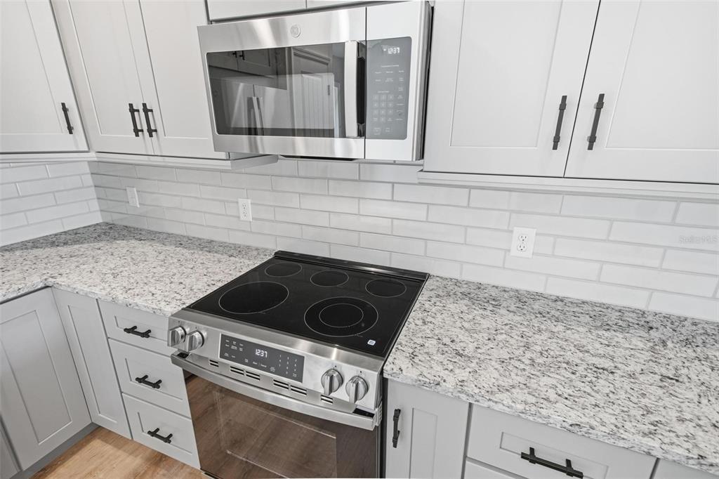 1730 Berrybush Street Bunnell, FL 32110 - Photo 15 of 43 a stove top oven sitting inside of a kitchen