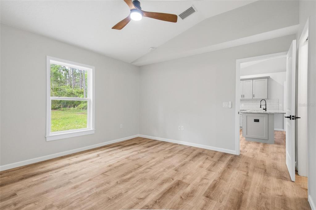 1730 Berrybush Street Bunnell, FL 32110 - Photo 18 of 43 wooden floor in an empty room with a window