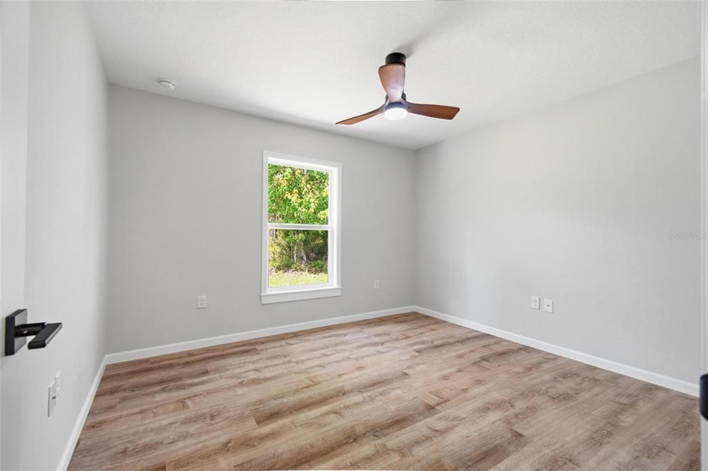 1730 Berrybush Street Bunnell, FL 32110 - Photo 27 of 43 wooden floor in an empty room with a window
