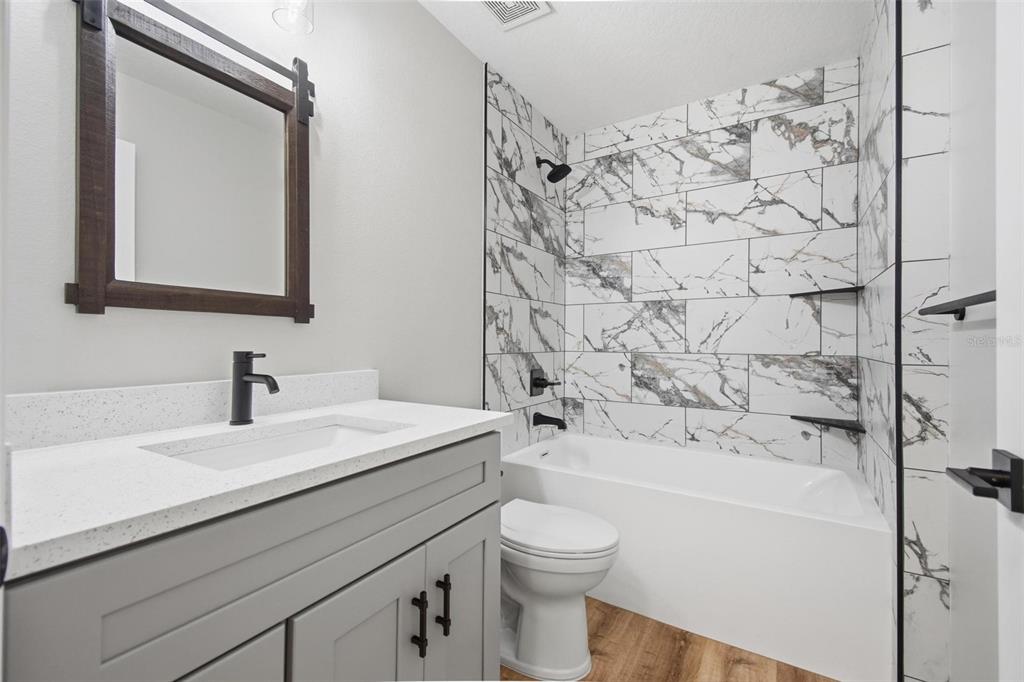 1730 Berrybush Street Bunnell, FL 32110 - Photo 29 of 43 a bathroom with a sink a toilet and shower