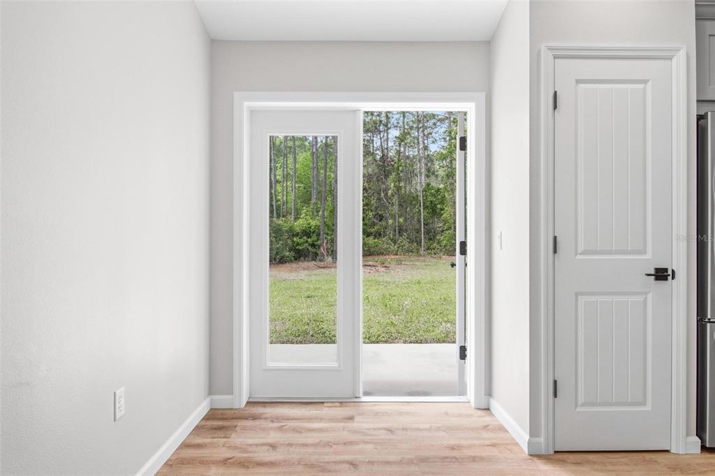 1730 Berrybush Street Bunnell, FL 32110 - Photo 34 of 43 a view of an empty room with wooden floor and next to a window