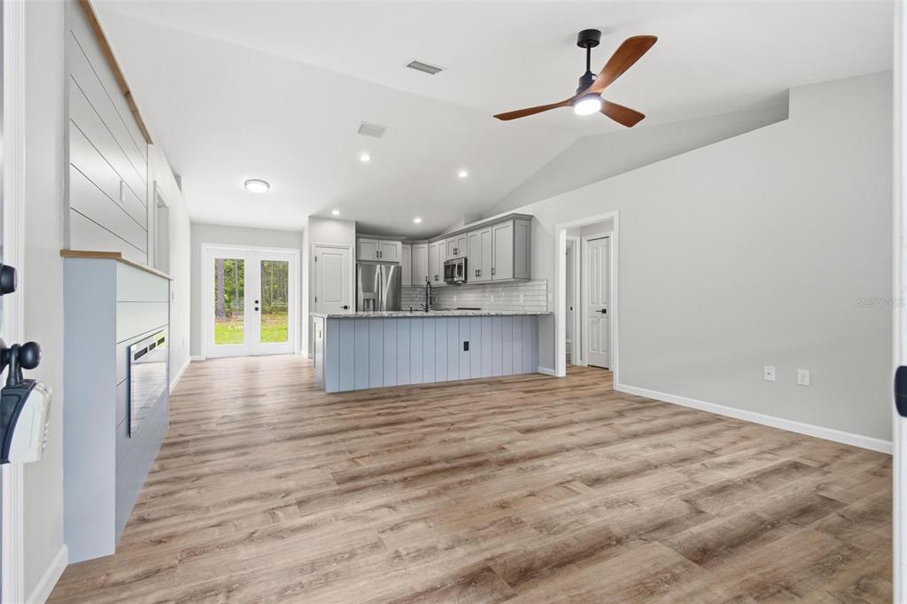 1730 Berrybush Street Bunnell, FL 32110 - Photo 4 of 43 a view of kitchen and empty room with wooden floor
