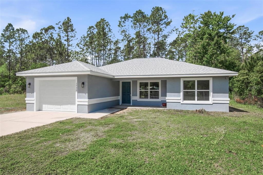 1730 Berrybush Street Bunnell, FL 32110 - Photo 41 of 43 a front view of a house with a garden and yard