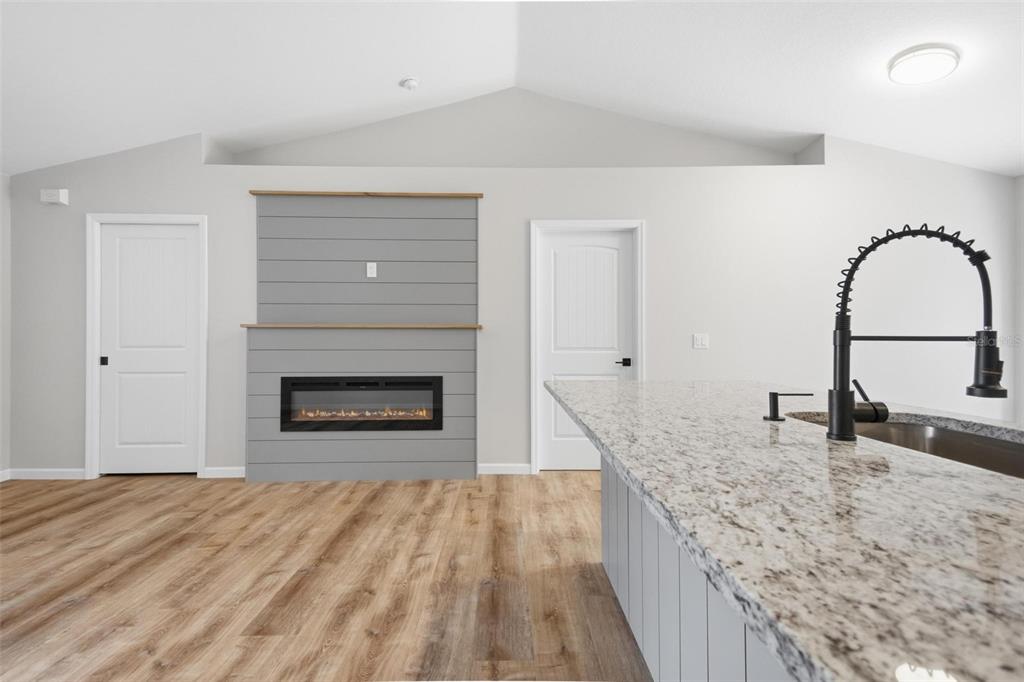 1730 Berrybush Street Bunnell, FL 32110 - Photo 5 of 43 a kitchen with granite countertop a sink and a stove