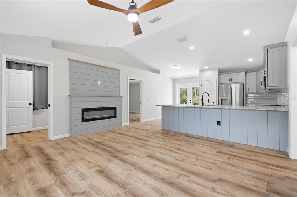 1730 Berrybush Street Bunnell, FL 32110 - Photo 7 of 43 a view of kitchen with kitchen island wooden floor and window