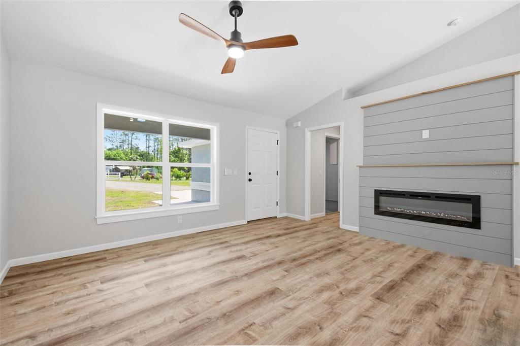1730 Berrybush Street Bunnell, FL 32110 - Photo 8 of 43 a view of an empty room with a fireplace and a window