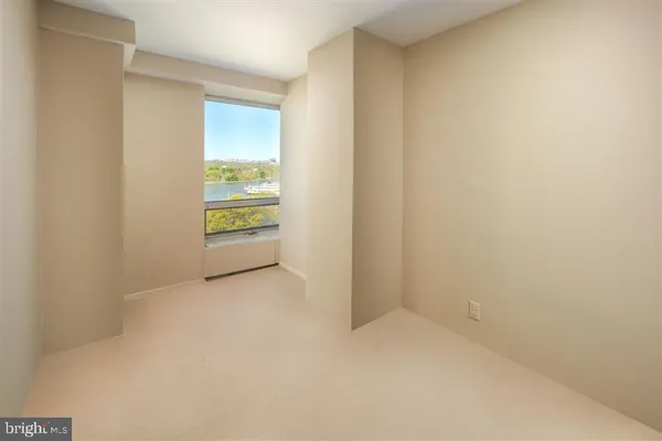 a view of an empty room with a closet