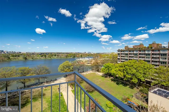 a view of a lake with a table and chairs