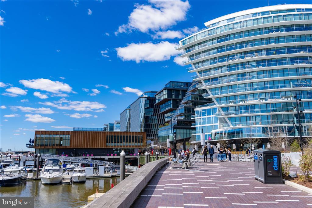 1425 4th Street Southwest, Unit A712 Washington, DC 20024 - Photo 28 of 38 a view of a swimming pool with a table and chairs