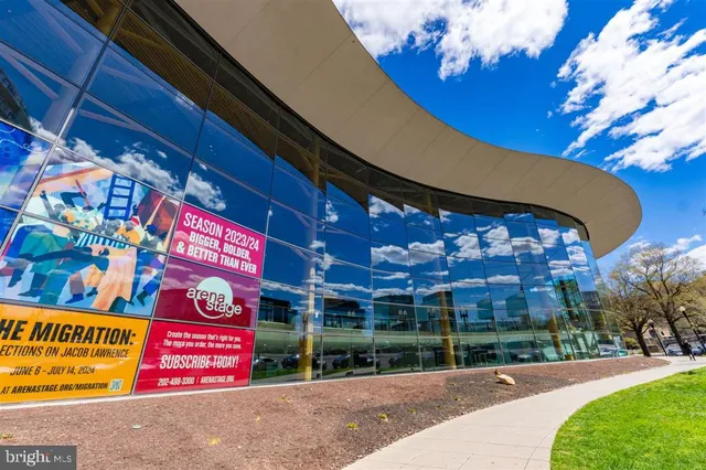 a view of street along with lots of potted plants