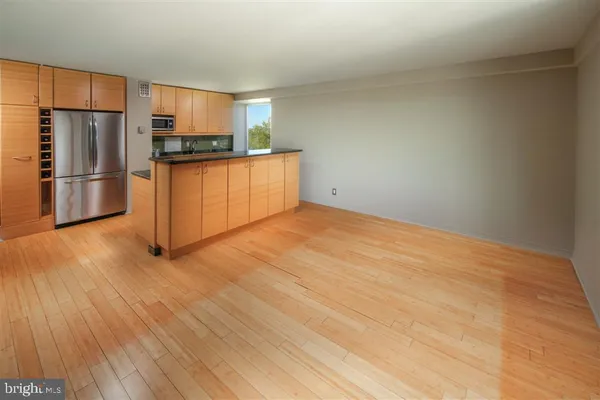 a kitchen with stainless steel appliances a refrigerator and a stove top oven