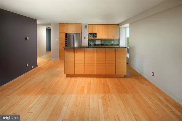 a view of a room with wooden floor and a window
