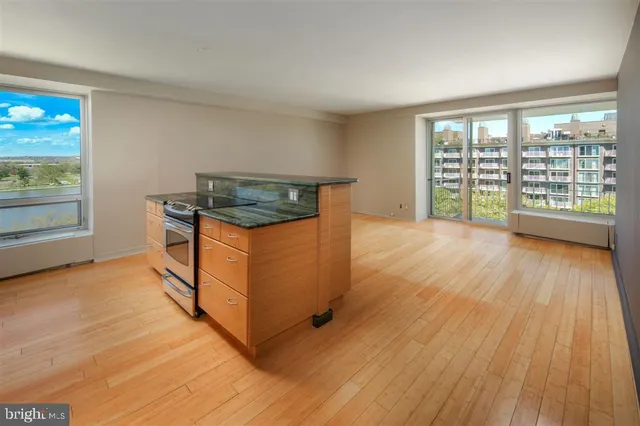 a view of a room with wooden floor and iron stairs