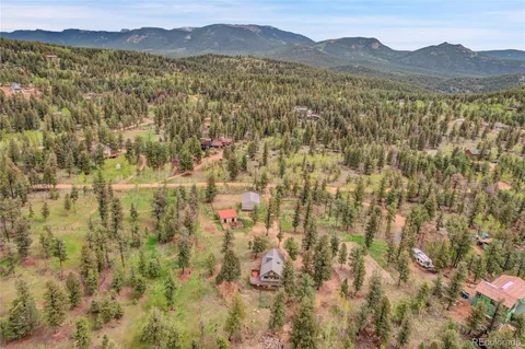 a view of a lush green hillside and a houses