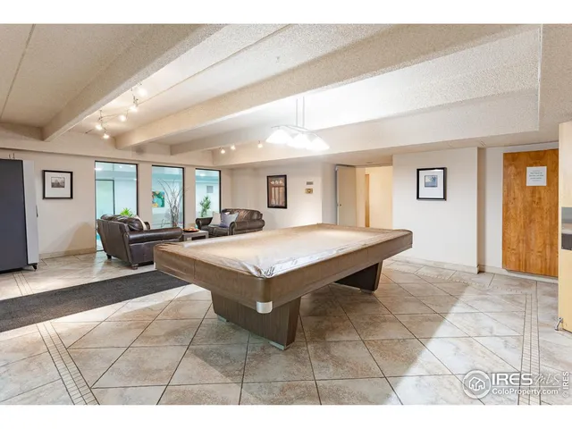 a living room with lots of furniture and painting on the wall